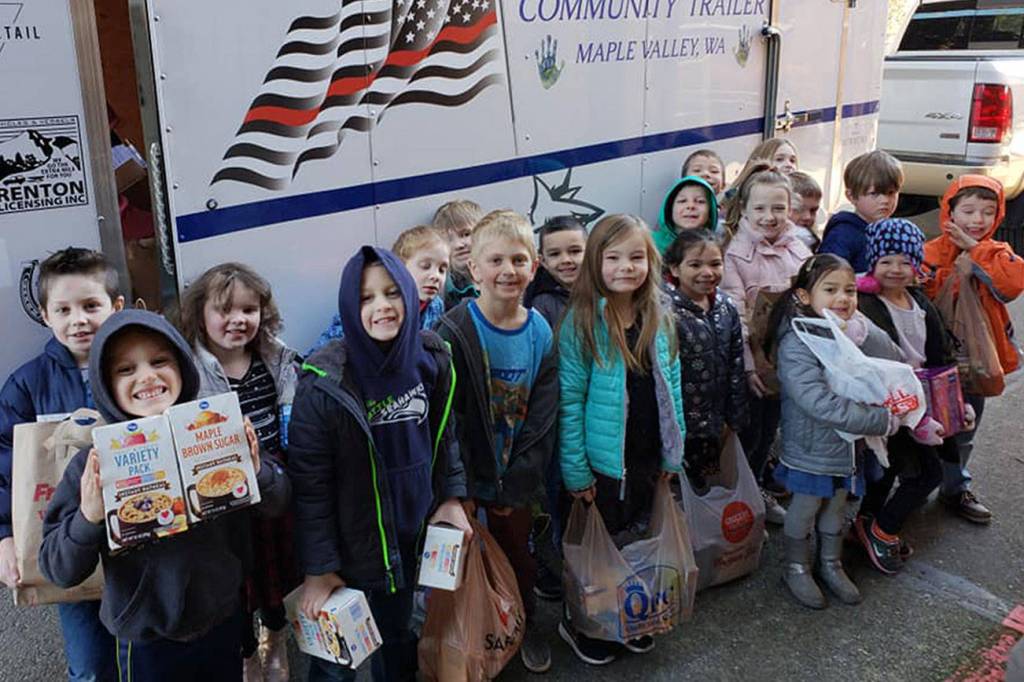Students from Lake Wilderness Elementary School show off donated food bags they gave to Backpack Buddies for Kids. The Maple Valley nonprofit gives students with food insecurity meals for the weekend and now for the summer.                                Photo courtesy of Backpack Buddies for Kids of Maple Valley.