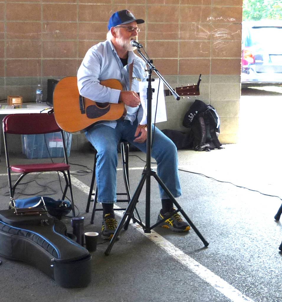 Jim Hanna preforms songs at the Maple Valley Farmers Market during its opening day on June 15.