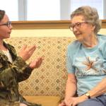 Hailey Hough talks with a senior at the Fountain Court Senior Living in Maple Valley after her and fellow Shadow Lake Classmates handed out painted tiles.