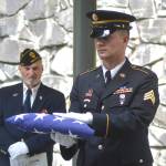 A military leader presents the American flag during former Tahoma High teacher Bill Pringles memorial service on June 25. Photo by Kayse Angel
