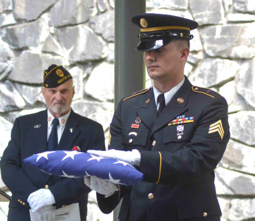 A military leader presents the American flag during former Tahoma High teacher Bill Pringles memorial service on June 25. Photo by Kayse Angel