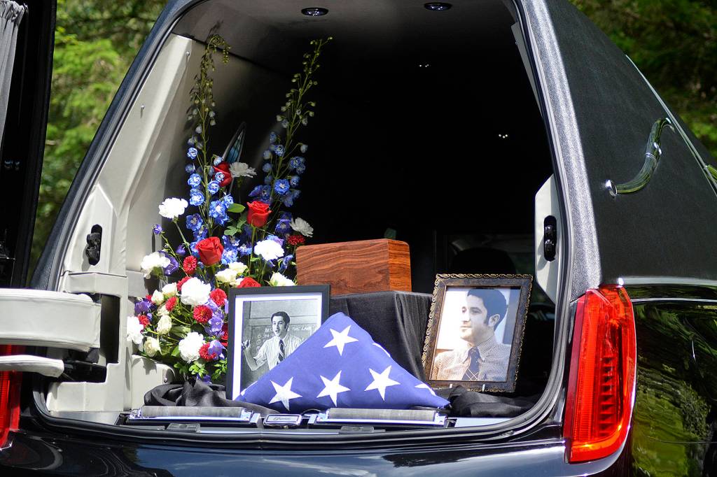 A hearse holds photos of former Tahoma High teacher Bill Pringle, along with his ashes and the American flag during his memorial service on June 25. Photo by Kayse Angel