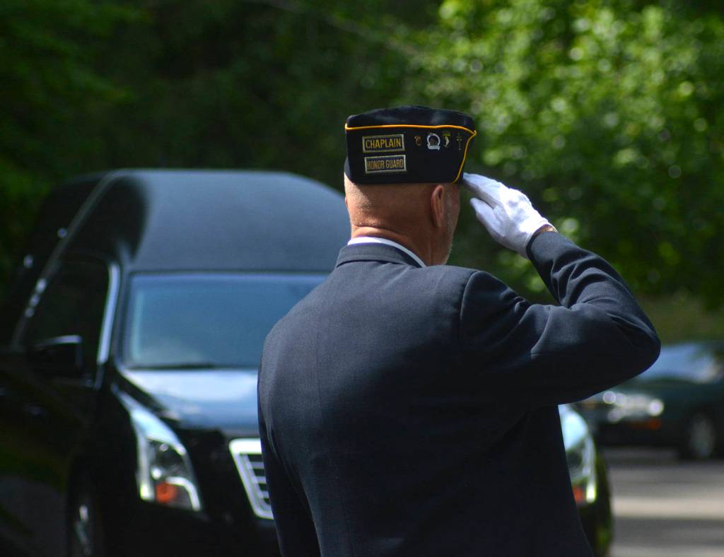 A serviceman salutes the hearse carrying former Tahoma High teacher and veteran, Bill Pringles ashes at the memorial service on June 25. Photo by Kayse Angel