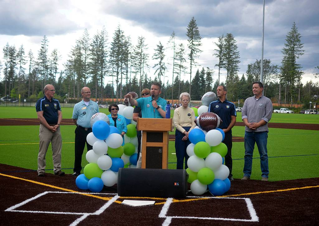 Mayor Sean Kelly and Maple Valley Council members stand on first base of one of the ballfields at the new Summit Park to speak to a crowd of people who came to celebrate on July 18. Photo by Kayse Angel