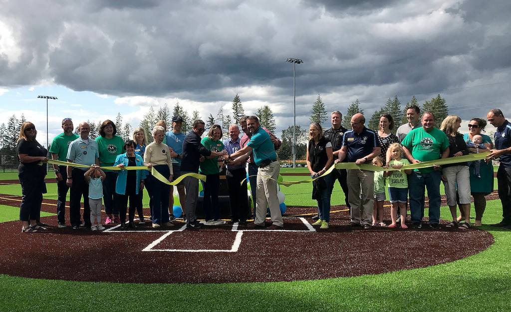 City staff and council members cut the ribbon during the Summit Park ribbon cutting on July 18. Photo by Kayse Angel