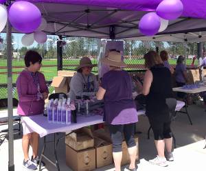 Be the Hope Walkers check out items up for sale at the Be the Hope Walk at Summit Park in Maple Valley. Photo by Kayse Angel