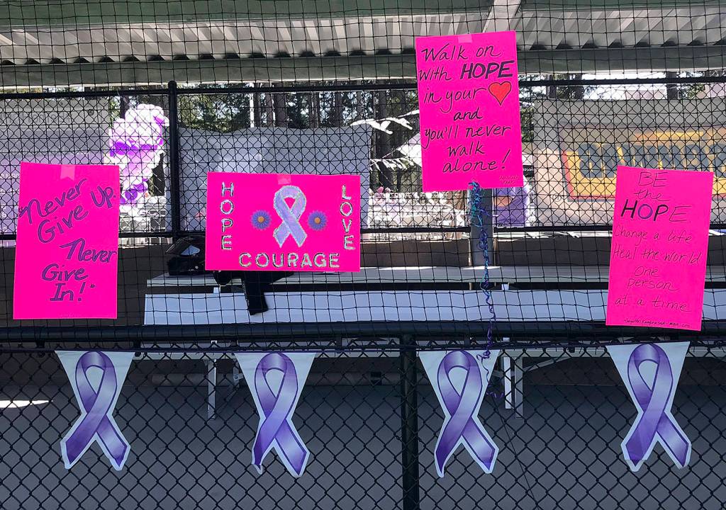 Signs with inspirational words hang at the dug out during the Be the Hope Walk on July 20 at Summit Park in Maple Valley. Photo by Kayse Angel