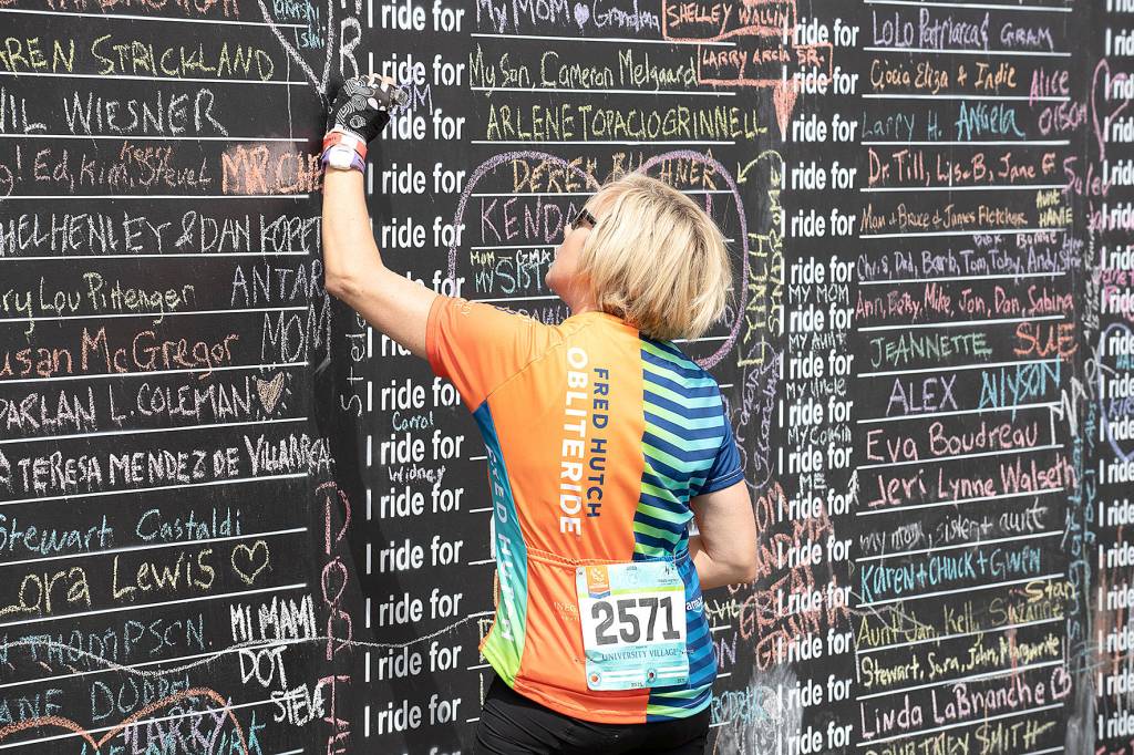 A Obliteride event participant writes the name of someone they love who was affected by cancer, which is why those choose to raise funds for Fred Hutchs cancer research. Photo courtesy of Fred Hutch Obliteride.                                 A Obliteride event participant writes the name of someone they love who was affected by cancer, which is why those choose to raise funds for Fred Hutchs cancer research. Photo courtesy of Fred Hutch Obliteride.