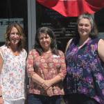 Photo by Danielle Chastaine                                  From left to right: Plateau Outreach Ministries Director Elaine Olson, Outreach Case Manager for Veterans and Seniors Lisa Napolitano, and Director Elisha Smith-Marshall stand outside of their nonprofits office. The trio work together regularly to help lift up the vulnerable populations in Enumclaw, Black Diamond and Covington.