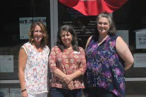 Photo by Danielle Chastaine                                  From left to right: Plateau Outreach Ministries Director Elaine Olson, Outreach Case Manager for Veterans and Seniors Lisa Napolitano, and Director Elisha Smith-Marshall stand outside of their nonprofits office. The trio work together regularly to help lift up the vulnerable populations in Enumclaw, Black Diamond and Covington.
