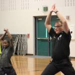 Chief McCurdy shows a Cedar Heights Middle School student how to stretch before an exercise routine. Photo by Danielle Chastaine.                                 Chief McCurdy shows a Cedar Heights Middle School student how to stretch before an exercise routine. Photo by Danielle Chastaine.