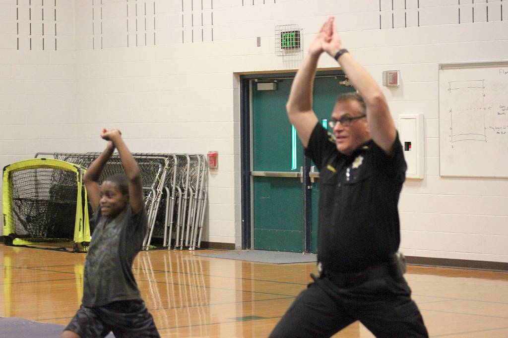 Chief McCurdy shows a Cedar Heights Middle School student how to stretch before an exercise routine. Photo by Danielle Chastaine.                                 Chief McCurdy shows a Cedar Heights Middle School student how to stretch before an exercise routine. Photo by Danielle Chastaine.
