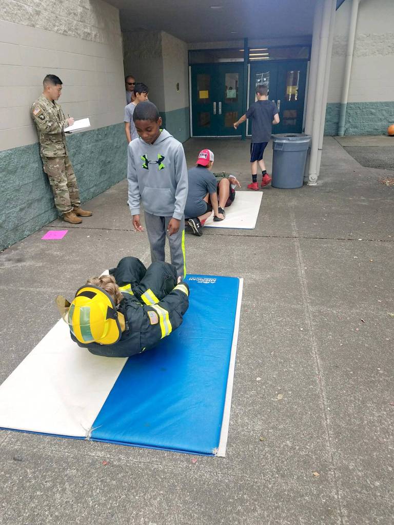 Photos by Danielle Chastaine.                                  Students in the Barbells and Badges summer camp at Cedar Heights Middle School compete on team firefighter or team police on Friday, Aug. 9. Photo courtesy of the Covington Police Department.
