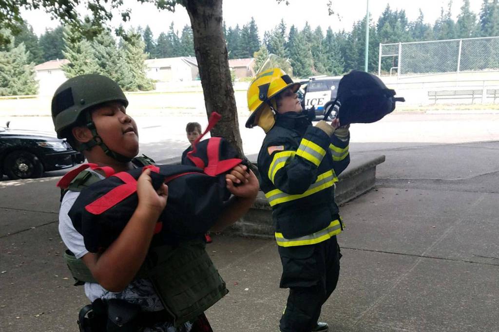 Photos by Danielle Chastaine.                                  Students in the Barbells and Badges summer camp at Cedar Heights Middle School compete on team firefighter or team police on Friday, Aug. 9. Photo courtesy of the Covington Police Department.