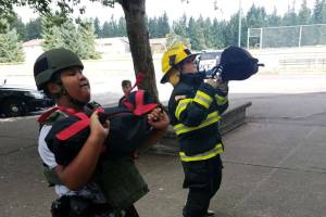 Photos by Danielle Chastaine.                                  Students in the Barbells and Badges summer camp at Cedar Heights Middle School compete on team firefighter or team police on Friday, Aug. 9. Photo courtesy of the Covington Police Department.