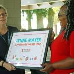 MARK KLAAS, Kent Reporter                                 State Rep. Debra Entenman, D-Covington, right, presents the No Kid Hungrys 2019 Summer Meals Hero award to Kent School Districts Lynne Mayer during an impromptu ceremony Thursday at Lake Meridian Park.