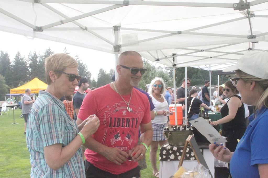 Photos by Danielle Chastaine                                 Residents tried cheese, cider and sausages from local vendors on Saturday, Aug. 17.