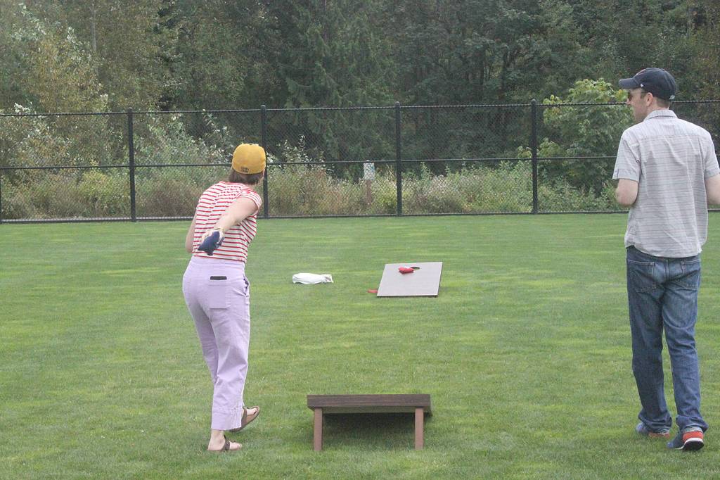 Cider Fest goers enjoyed listening to live music while playing yard games, such as corn hole. Photo by Danielle Chastaine.