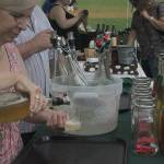 The cider poured into multiple sample cups while local brewers gave away tastes at the 2019 Sausage and Cider Fest.