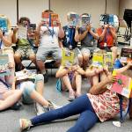Photo courtesy of the Covington Chamber of Commerce.                                 Children read together at the Covington Library while out of school to earn a brag badge with the Covington Play Unplugged challenge.