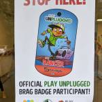 A sign shows what local businesses are participating in the Play Unplugged challenge, hosted by the Covington Chamber of Commerce and the Kent School District. Photo courtesy of the Covington Chamber of Commerce.