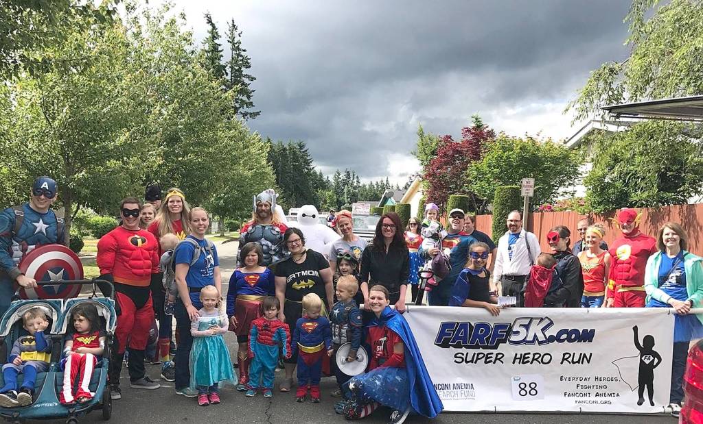 Photo courtesy of FARF 5K.                                 A large group photo of the FARF 5K organizers, sponsors and runners. The fun run supports medical research into fanconi Anemia.