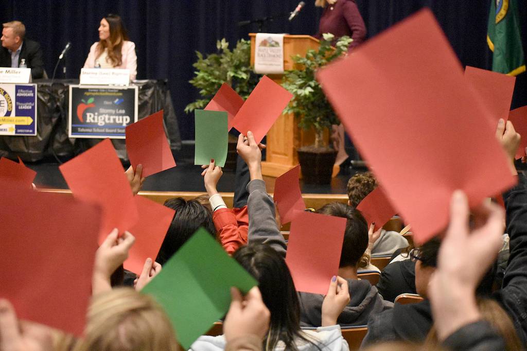 Photo by Haley Ausbun. One segment of the Maple Valley Candidate forum, Oct. 17 at Tahoma High School, included asking candidates yes or no questions by raising a red or green card, and asking the audience to use red or green cards to represent their opinion.