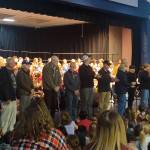 Veterans in the crowd were asked to stand near the stage during a special Veterans Day Assembly. Veterans introduced themselves, said where they served and for what military branch, and were given roses as a thank you for their service by the Glacier Park Elementary School fifth grade class. Photo by Danielle Chastaine.                                 Veterans in the crowd were asked to stand near the stage during a special Veterans Day Assembly. Veterans introduced themselves, said where they served and for what military branch, and were given roses as a thank you for their service by the Glacier Park Elementary School fifth grade class. Photo by Danielle Chastaine.