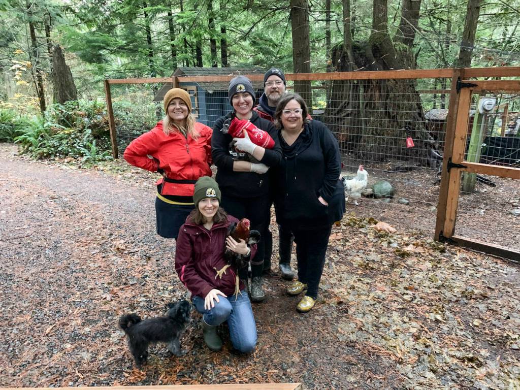 Volunteers help out at a Sunday work party at Rooster Haus Rescue in Fall City. From left, top: Jenny Rae, Littles the dog, Nikki Waters, John Higgins, Gina Erskine. From left, bottom: Yoshi the dog, Ashley Ventura, Manny the rooster. Natalie DeFord/staff photo