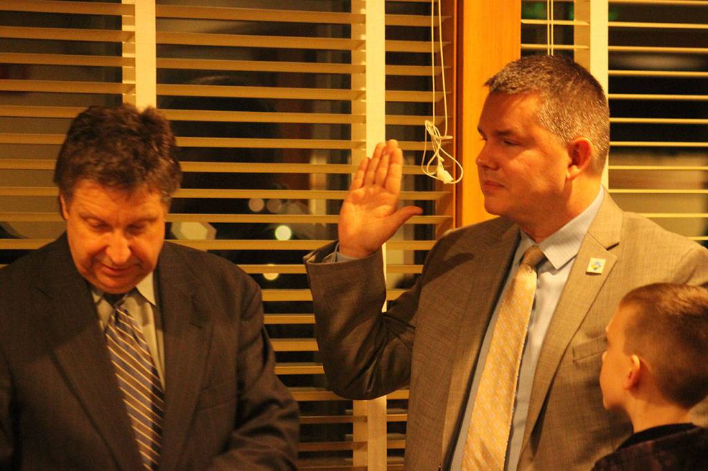 Maple Valley Mayor Sean P. Kelly takes the Oath of Office with his son in attendance during the first council meeting of the year on Monday, Jan. 6, 2019. Photo by Danielle Chastaine.
