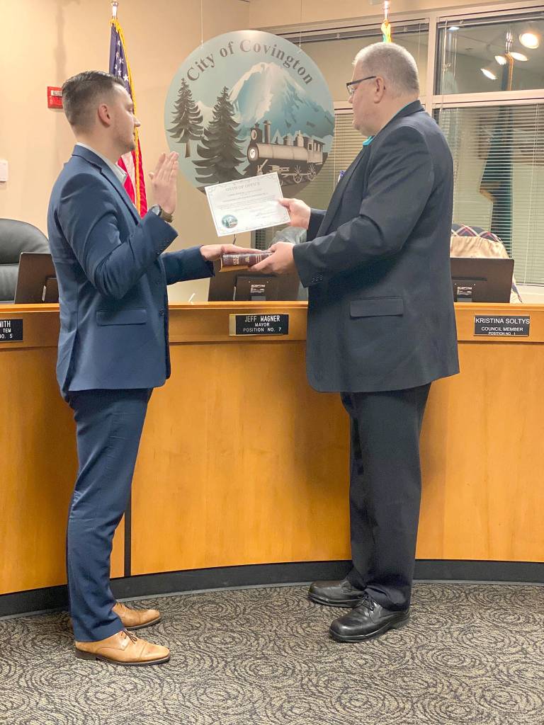 Newley elected Covington City Councilmember, and youngest serving councilmember, Jared Koukal is sworn-in by Mayor Jeff Wagner during the Tuesday, Jan. 14, regular council meeting. Photo by Karla Slate.