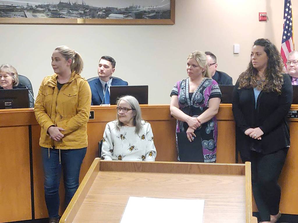 From left to right; Megan Stevens, her mother Debra Stevens and Laura Mitchell listen to local speakers talk about the importance of CPR during the Covington City Council regular meeting on Monday, Jan. 27, 2020. During the meeting Mitchell was honored for her efforts in saving Debra Stevens life by performing CPR. Photo by Danielle Chastaine.