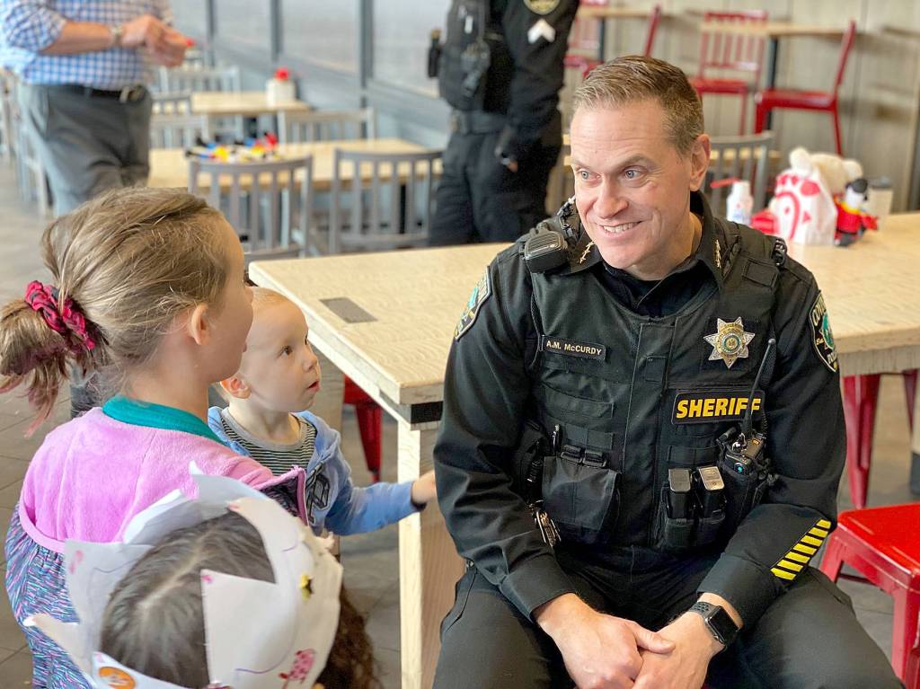Covington Police Chief Andrew McCurdy speaks with local kids about police work and safety during the Coffee with a Cop event at the Covington Chick-fil-A on Monday, Feb. 10, 2020. Photo courtesy of the City of Covington.