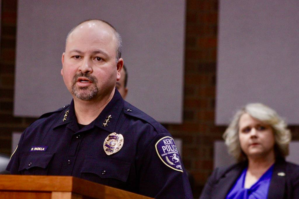 Kent Police Chief Rafael Padilla, with Mayor Dana Ralph listening, talks to the media about the King County-owned quarantine/isolation facility in Kent during a news conference Friday. City officials are concerned about the safety of the former Econo Lodge motel after a patient fled from the facility, shoplifted a convenience store and boarded a bus. MARK KLAAS, Kent Reporter
