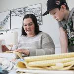 Angie Adam has been using materials given to her from her great grandmother to sew masks for healthcare workers. Photo by Ray Miller-Still