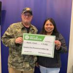 Martin Coon and his wife Khristine hold the $75,000 check after winning Washingtons Lottery. Courtesy photo