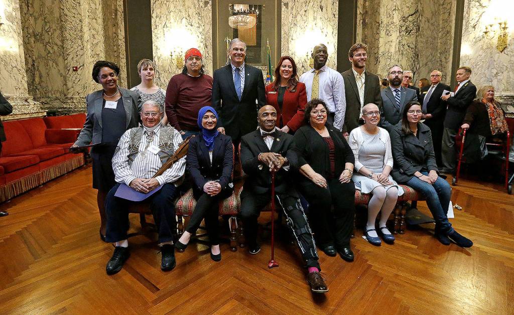 Democratic electors and state officials pose for a photo after a meeting of the states Electoral College in December 2016. Seated, from left, are Dan Carpita, Varisha Khan, Phillip Tyler, Julie Johnson, Elizabeth Caldwell and Levi Guerra. Standing, from left, are Esther John, Ryleigh Ivey, Robert Satiacum, Gov. Jay Inslee, Secretary of State Kim Wyman, Chris Porter, Eric Herde and Bret Chiafalo. Chiafalo, of Everett, along with John and Guerra did not cast their votes in the Electoral College for Democratic candidate Hillary Clinton, who won the states popular vote. (AP Photo/Elaine Thompson, file)