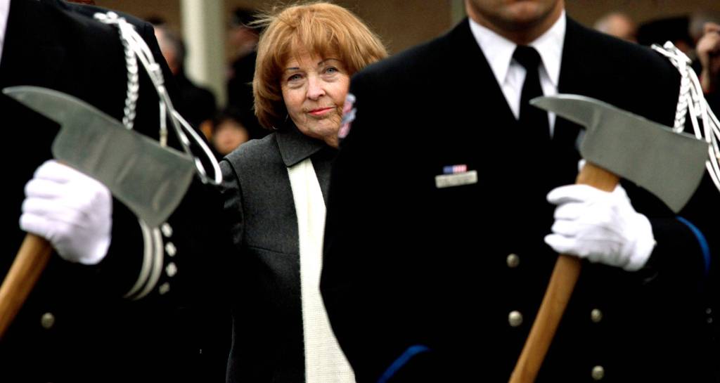 Kathy Parks, wife of slain firefighter Gary Parks, walks in a processional to place a flower on the memorial for her husband on the Everett Community College campus in 2012. (Michael OLeary / Herald file)