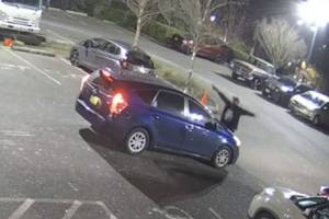 A screenshot from private surveillance footage provided by the Seattle Police Department shows a suspect engaging with the occupants of a vehicle on Feb. 9, 2021, in Seattle. The suspect shot the vehicles two occupants, one fatally, before he was killed by police. File photo