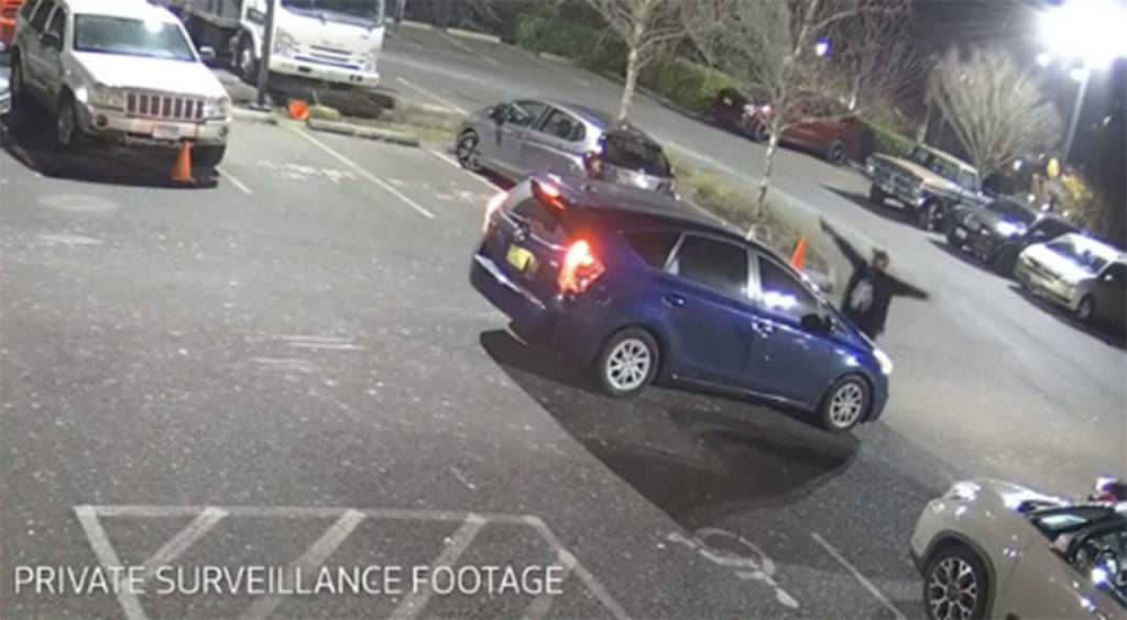 A screenshot from private surveillance footage provided by the Seattle Police Department shows a suspect engaging with the occupants of a vehicle on Feb. 9, 2021, in Seattle. The suspect shot the vehicles two occupants, one fatally, before he was killed by police. File photo