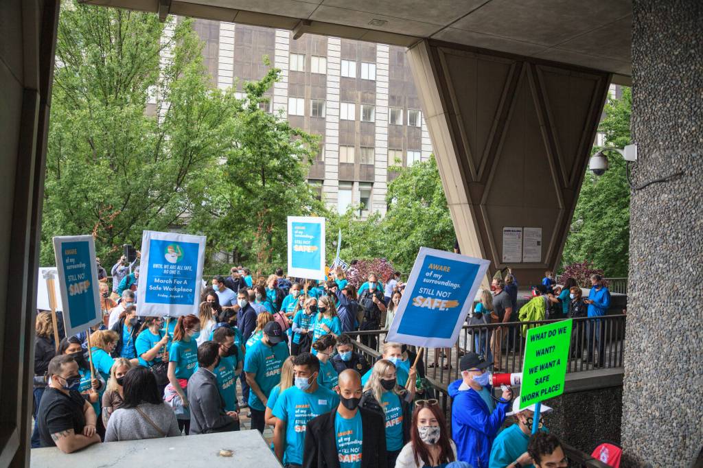 County employees and supporters file out of the courtyard at the King County Administration building during a march for womens safety at work in Seattle on Friday, Aug. 6, 2021. The march was scheduled after a woman was attacked in a bathroom at the King County Courthouse. Photo by Henry Stewart-Wood/Sound Publishing
