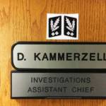A screenshot from an investigators report about the Nazi symbol Kent Police Assistant Chief Derek Kammerzell placed above his nameplate on his office door.