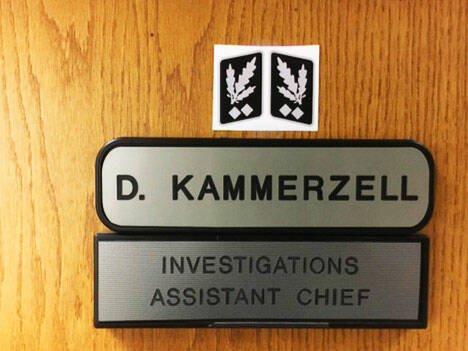 A screenshot from an investigators report about the Nazi symbol Kent Police Assistant Chief Derek Kammerzell placed above his nameplate on his office door.