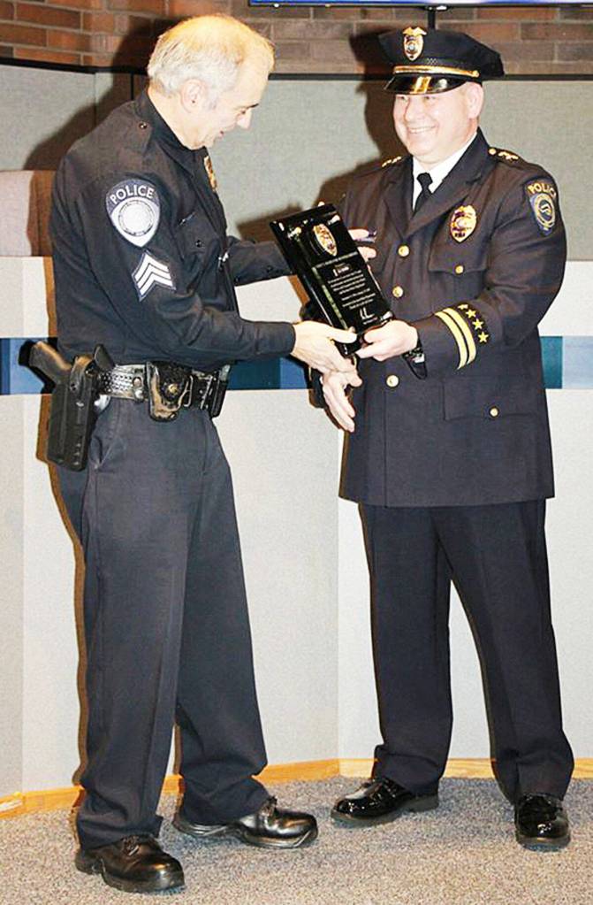 Derek Kammerzell, right, honors retiring Sgt. Joe Gagner in this 2018 photo. COURTESY PHOTO, Kent Police