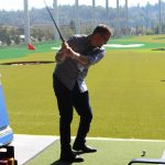 Renton Mayor Armondo Pavone takes a swing on opening day at Topgolf Renton. Photo by Bailey Jo Josie/Sound Publishing