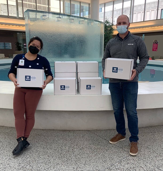 WGU staff works with Shelly Caldejon from the UW Valley Medical Center to deliver packages to 200 employees. COURTESY PHOTO, WGU