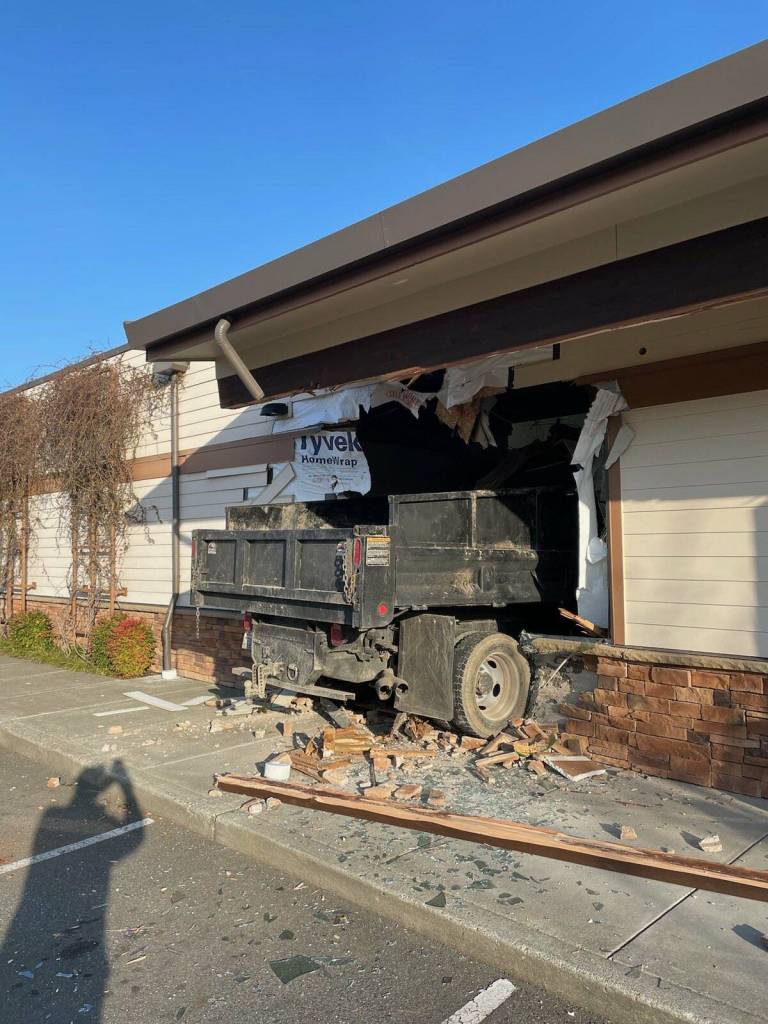 The truck was in the parking lot near the Maple Valley Eye Care Center before crashing into the building. Photo courtesy of Puget Sound Regional Fire Authority.