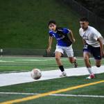 Auburn Riversides Brian Silva-Espinoza in a race to the ball with a Kent-Meridian player. Ben Ray/ The Reporter