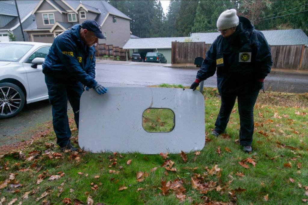 The plane door that flew off of the Alaska Airlines flight 1282 Boeing 737-9 MAX found by NTSB investigators in a Portland residents backyard. (Courtesy of NTSB)