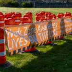 Sixty-one orange traffic barrels were set up April 2, 2024, on the WSDOT front lawn in Olympia. Each cone represents a fallen WSDOT employee killed on the job since 1950 - many in active work zones. The visual display is meant to remind everyone of the importance of slowing down in work zones. Photo courtesy of Washington State Department of Transportation.